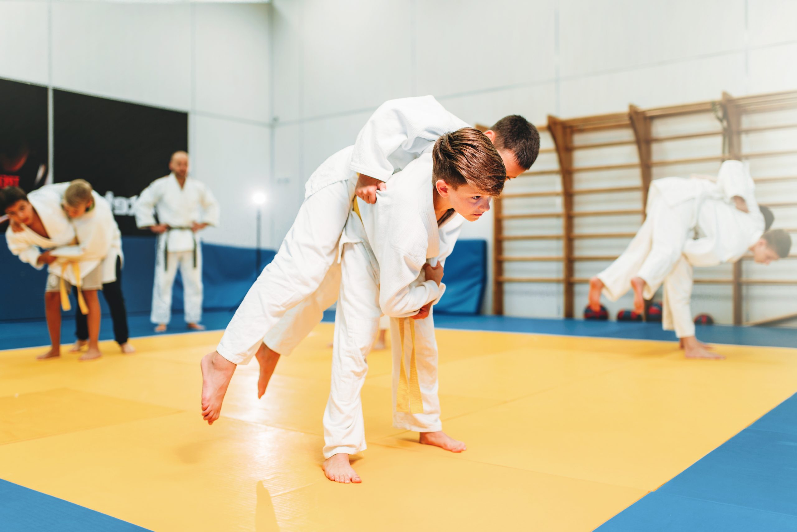 Kid judo, young fighters on training, self-defense. Little boys in kimono practice martial art
